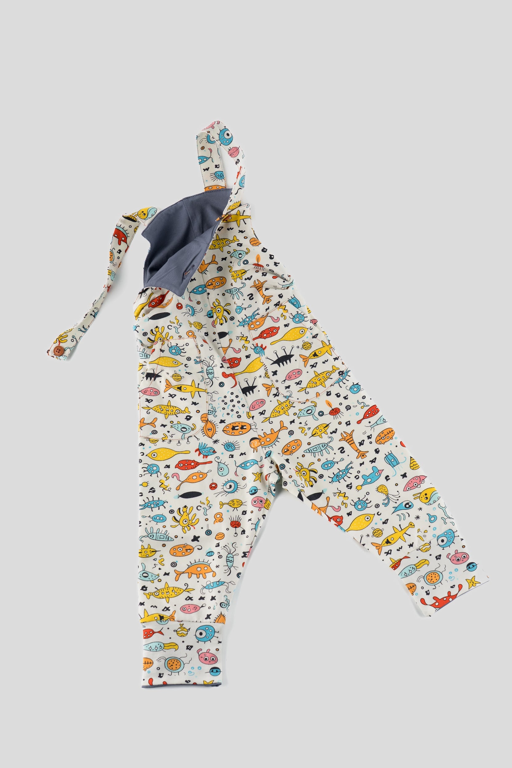 Children's outfit with colorful animal pattern on a light gray background