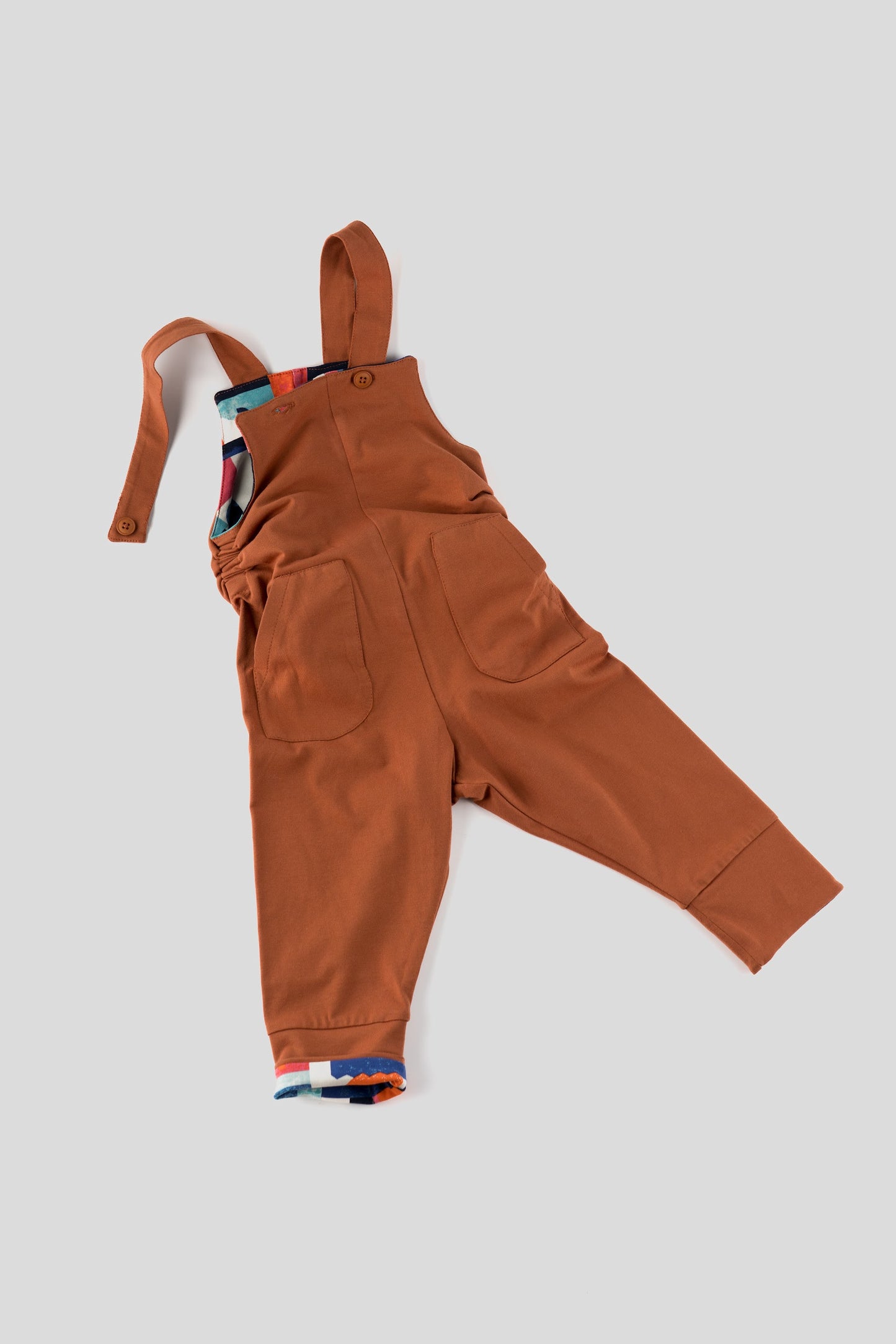 Brown overalls on a light gray background
