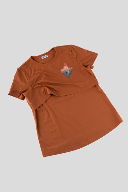 Brown t-shirt with a small graphic on a light gray background